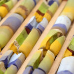 close up of a box of broken striped pastels in landscape colours
